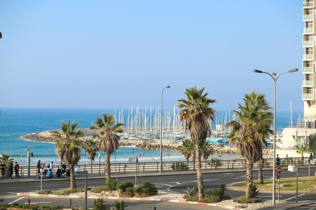 View towards the sea and palm-lined promenade across HaYarkon Street