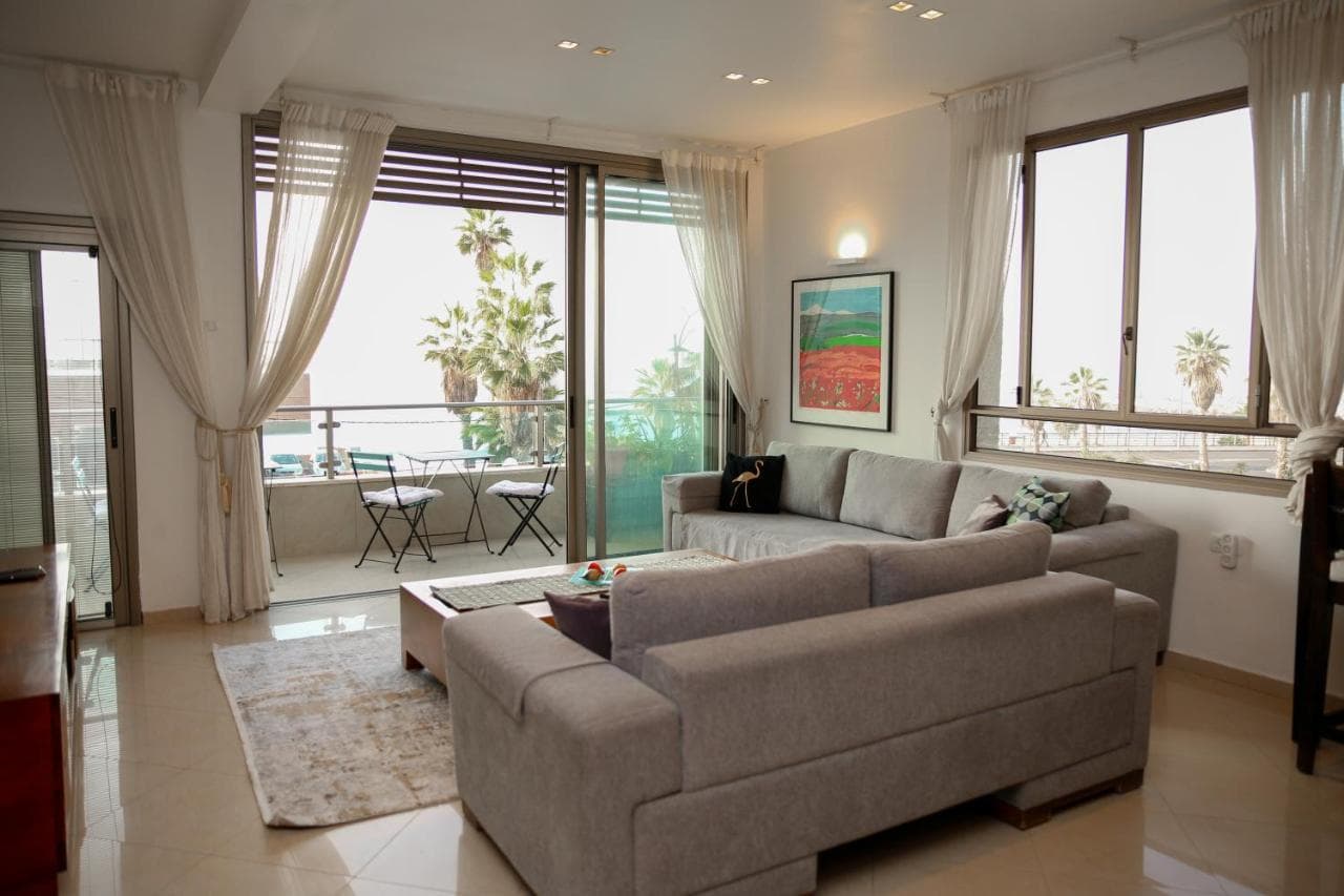Living room with sofas and glass doors opening onto the balcony