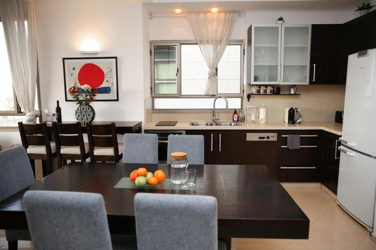 Dining table beside the open kitchen
