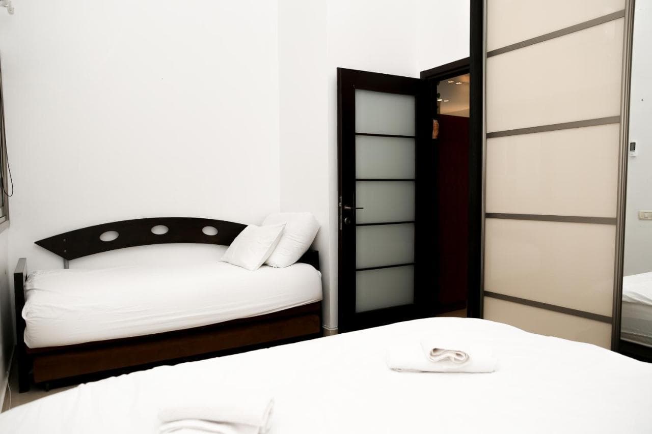 Bedroom with two beds and a wardrobe